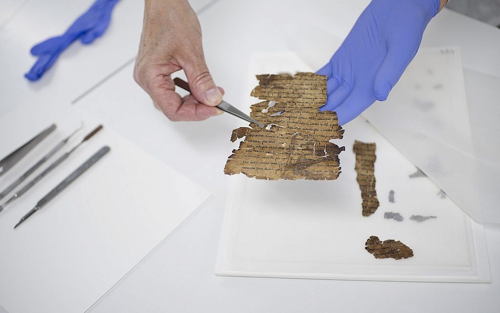 Preservation work of a Dead Sea Scroll fragment. (Shai Halevi, The Leon Levy Dead Sea Scrolls Digital Library)