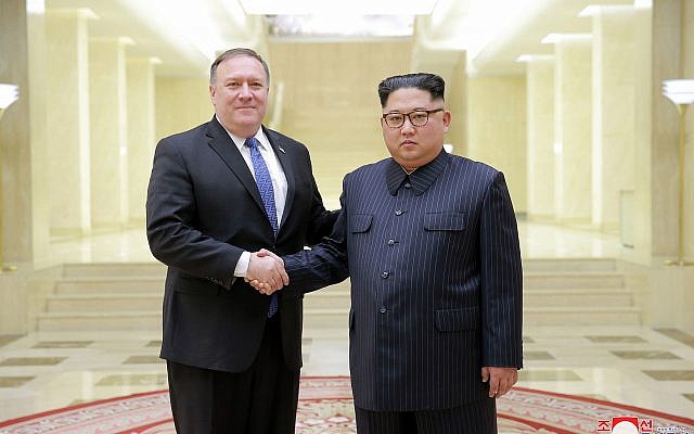 In this May 9, 2018, photo provided on May 10, 2018, by the North Korean government, US Secretary of State Mike Pompeo, left, poses with North Korean leader Kim Jong Un in Pyongyang, North Korea. (Korean Central News Agency/Korea News Service via AP)