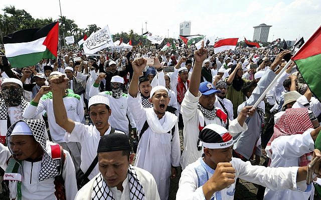Protesters shout slogans "God is Great" during a rally against the US plan to move its embassy in Israel from Tel Aviv to Jerusalem, at Monas, the national monument, in Jakarta, Indonesia, May 11, 2018. (AP Photo/Achmad Ibrahim)