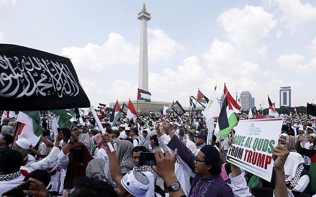 Protesters wave Palestinian flags during a rally against the US plan to move its embassy in Israel from Tel Aviv to Jerusalem, at Monas, the national monument, in Jakarta, Indonesia, May 11, 2018. (AP Photo/Achmad Ibrahim)