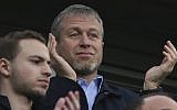 Chelsea's Russian owner Roman Abramovich applauds his players after they defeated Arsenal 6-0, in an English Premier League soccer match at Stamford Bridge stadium in London, on March 22, 2014. (AP Photo/Alastair Grant)