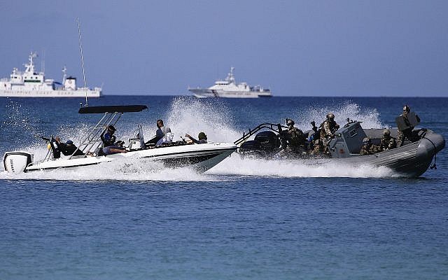 Members of the Philippine Navy Seals, right, maneuver during an anti-terrorism drill at the country's most famous beach resort island of Boracay, in central Aklan province, Philippines on April 25, 2018. (AP /Aaron Favila)