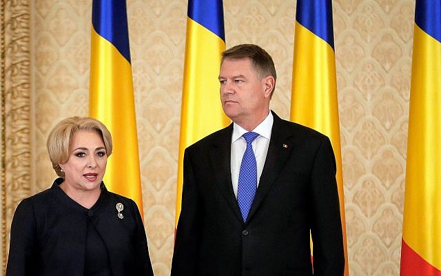 Romanian Prime Minister Viorica Dancila, left, stands next to Romania's President Klaus Iohannis, after the swearing in of her cabinet, in Bucharest, Romania, on January 29, 2018. (AP/Vadim Ghirda)
