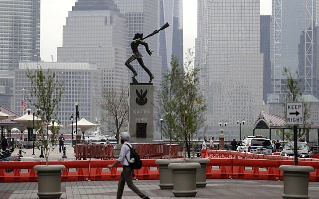 A man walks in front of a statue dedicated to the victims of the Katyn massacre of 1940, Friday, May 4, 2018, in Jersey City, N.J.  (AP Photo/Julio Cortez)