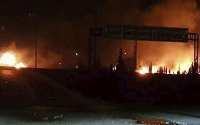 This photo released on Wednesday, May 9, 2018, by the Syrian official news agency SANA, shows flames rising after an attack in an area known to have numerous Syrian army military bases, in Kisweh, south of Damascus, Syria. Syrian state-run media said Israel struck a military outpost near the capital Damascus on Tuesday, saying its air defenses intercepted and destroyed two of the incoming missiles. The reported attack came shortly after U.S. President Donald Trump announced he was withdrawing from the Iran nuclear deal, calling Tehran a main exporter of terrorism in the region. (SANA via AP)