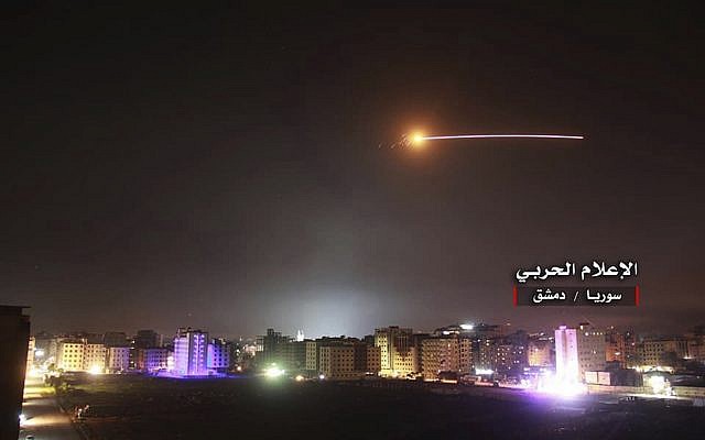 Syrian anti-aircraft missiles rise into the sky as Israeli missiles hit air defense positions and other military bases, in Damascus, Syria, on May 10, 2018. (Government-controlled Syrian Central Military Media, via AP)