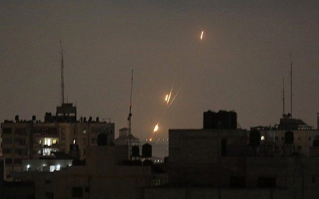 Illustrative: Flames from rockets fired by Palestinians are seen over Gaza Strip heading toward Israel, in the early morning of May 30, 2018. (AP Photo/Hatem Moussa)