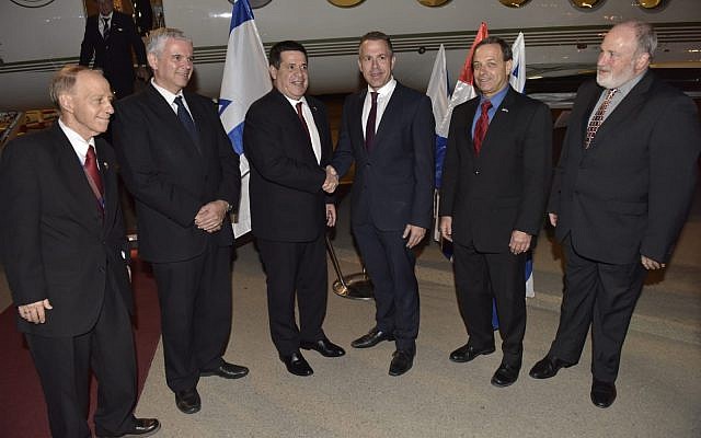 Paraguay' President Horacio Cartes (3rd-L) is greeted at Ben Gurion International Airport by Public Security Minister Gilad Erdan (3rd-R) after landing in Israel to attend the opening of the Paraguayan embassy in Jerusalem, on May 20, 2018. (Foreign Ministry)