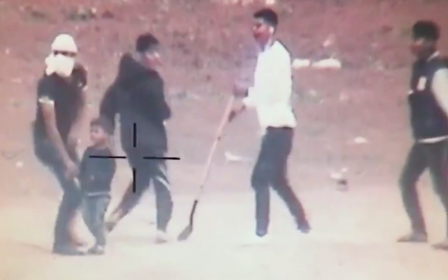 A small Gazan child next to youths during violent protests at the Gaza border, in footage released by the IDF on May 5, 2018 (screenshot)