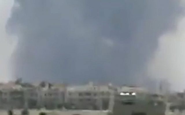 Smoke is seen following reports of explosions at Hama air base in Syria on May 18, 2018. (Screen capture: Twitter)