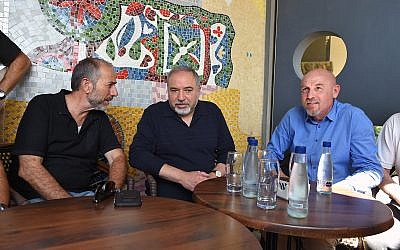 Defense Minister Avigdor Liberman (C) meets with Golan Regional Council head Eli Malka (L) and Katrzin Regional Council head Dmitry Apartzev (R) during a tour of the Golan Heights town of Katzrin on may 11, 2018. (Ariel Hermoni/Defense Ministry)