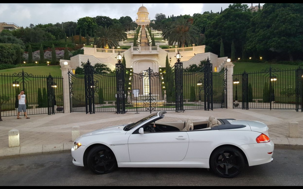 Screenshot from the Facebook page of "Richvei Hashalom" a luxury car dealership in Haifa, with a car against the backdrop of the Baha'i temple in Haifa. (Facebook).