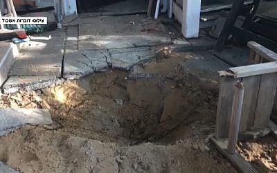 Crater outside home near Gaza border caused by rocket fired from coastal enclave on May 30, 2018. (Screen capture: Hadashot news/Eshkol Regional Council)