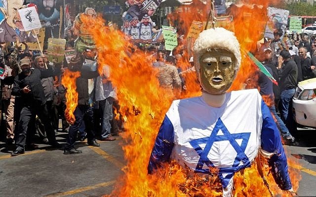 Iranians burn an effigy of US President Donald Trump dressed in an Israeli flag during a rally in Tehran to mark Jerusalem Day on June 8, 2018. (AFP Photo/STR)
