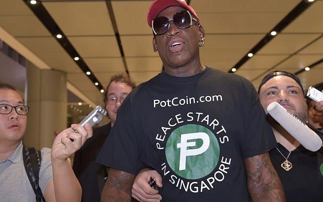 Retired American professional basketball player Dennis Rodman speaks to the press as he arrives at Changi International airport ahead of US-North Korea summit in Singapore, on June 11, 2018. (AFP PHOTO / ADEK BERRY)