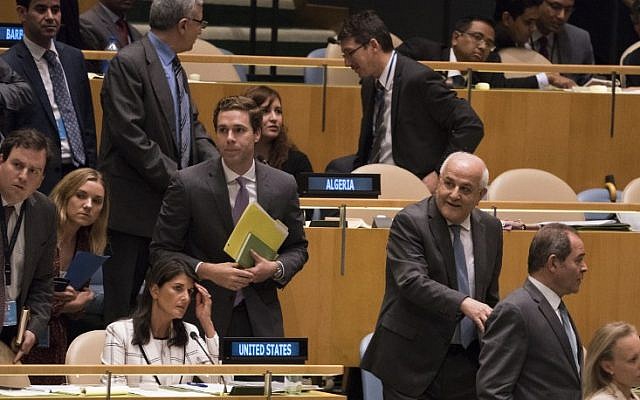 Palestinian Ambassador to the United Nations Riyad Mansour (white hair) passes by US Ambassador Nikki Haley (seated) during voting, to condemn Israeli actions in Gaza, in the General Assembly June 13, 2018 in New York. (AFP PHOTO / Don EMMERT)