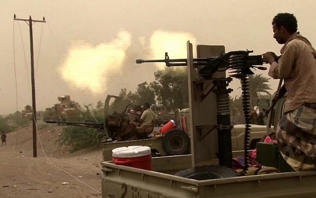 This image grab taken from a AFPTV video shows Yemeni pro-government forces firing a heavy machine gun at the south of Hodeida airport, in Yemen's Hodeida province, on June 15, 2018. (AFP Photo/AFPTV)