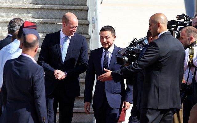 Prince William (L) is greeted at Amman's Marka military airport by Jordanian Crown Prince Hussein bin Abdullah on June 24, 2018. 
Prince William arrived in Jordan at the start of a Middle East tour that will see him become the first British royal to pay official visits to both Israel and the Palestinian territories. (AFP PHOTO / KHALIL MAZRAAWI)