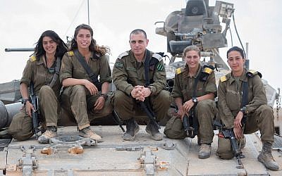 Head of the IDF Armored Corps Brig. Gen. Guy Hasson, center, poses on a tank with the army's first female tank commanders, who graduated their course on June 28, 2018. (Israel Defense Forces)