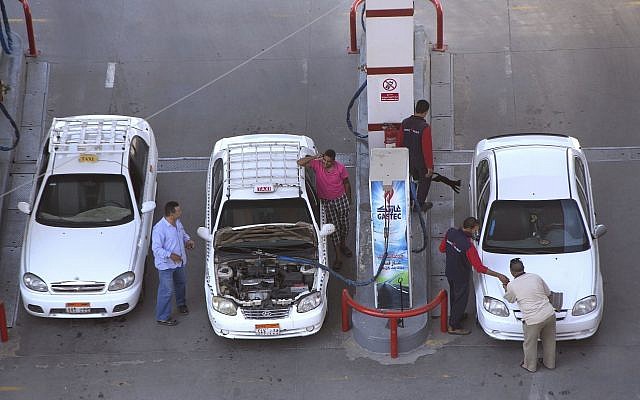 In this June 29, 2017, file photo, taxi drivers chat as they refuel their vehicles at a gas station in Cairo, Egypt. (AP Photo/Amr Nabil, File)