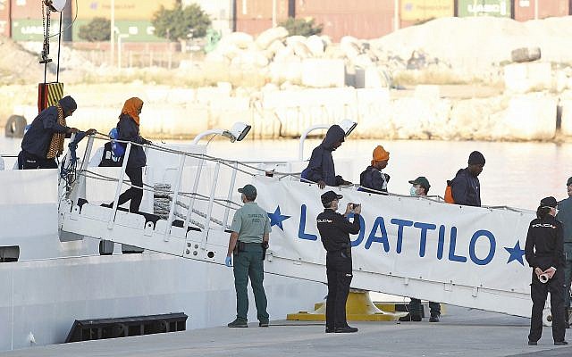 Migrants descend the Italian coast guard vessel Dattilo upon arrival at the eastern port of Valencia, Spain, Sunday, June 17, 2018. (AP/Alberto Saiz)