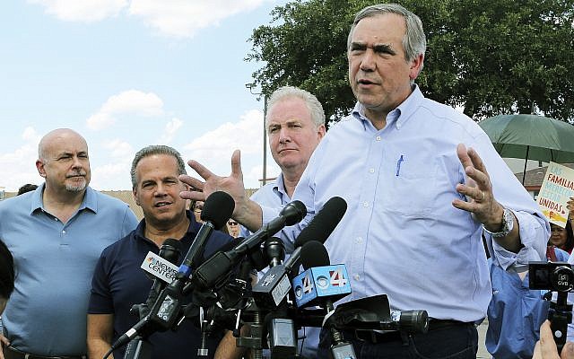 US Sen. Jeff Merkley, (right), from Oregon, speaks to the media along with US Sen. Chris Van Hollen, center, D-Md., US Rep. David Cicilline, D-RI, and US Rep. Mark Pocan, D-Wis., in front of the US Customs and Border Protection's Rio Grande Valley Sector's Centralized Processing Center in McAllen, Texas, June 17, 2018. (Joel Martinez/The Monitor via AP/ File)