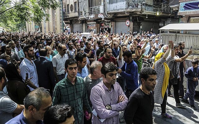 A group of protesters chant slogans at the old grand bazaar in Tehran, Iran, June 25, 2018. (Iranian Labor News Agency via AP)