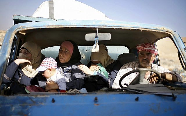 Syrian refugees gather in their vehicles getting ready to cross into Syria from the eastern Lebanese border town of Arsal, Lebanon, Thursday, June 28, 2018. Dozens of Syrian refugees in Lebanon have started to cross the border, going back home to war-torn Syria. (AP Photo/Bilal Hussein)