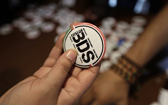 Illustrative: An Egyptian buys a pin with the Boycott, Divestment and Sanctions (BDS) logo in Cairo, Egypt, in 2015 (AP Photo/Amr Nabil)