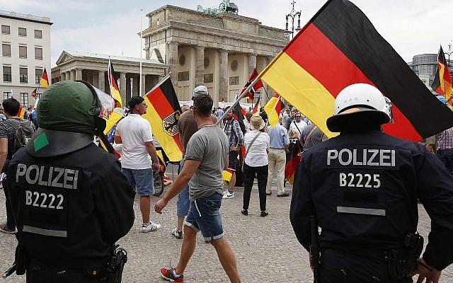 Supporters of German AfD wave flags in front of the Brandenburg Gate in Berlin, Germany, May 27, 2018. (AP Photo/Michael Sohn)