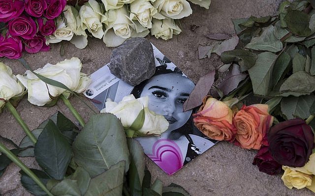 Roses cover the photo of the 14-year-old Susanna Maria Feldman killed in Wiesbaden, Germany, June 8, 2018 (Boris Roessler/dpa via AP)
