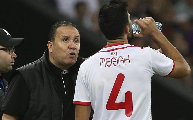 In this Saturday, June 9, 2018 file photo, Tunisia's head coach Nabil Maloul, left, speaks with Tunisia's Yassine Meriah, who drinks water during a friendly soccer match against Spain in Krasnodar, Russia. (AP Photo, File)