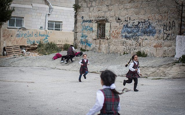 Palestinian schoolgirls play after school in the East Jerusalem neighborhood of Shuafat, March 30, 2016. (Hadas Parush/Flash90)