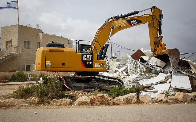 A bulldozer demolishes a homes in the Netiv Ha'avot outpost on June 13, 2018. (Gershon Elinson/Flash90)