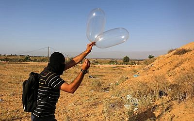 A Palestinian prepares a balloon that will be attached to flammable materials and then flown toward Israel near the Israeli-Gazan border, in Rafah in the southern Gaza Strip June 17, 2018. (Abed Rahim Khatib/Flash90)