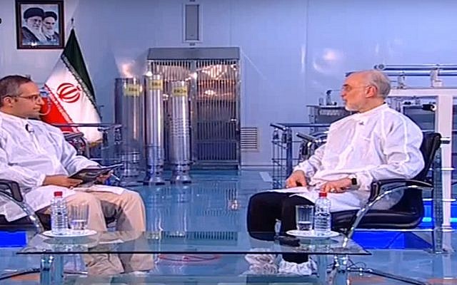 Screen capture from video showing Ali Akbar Salehi, the head of Iran's nuclear agency, right, and three Iranian produced uranium enrichment centrifuges in the center background. (YouTube)