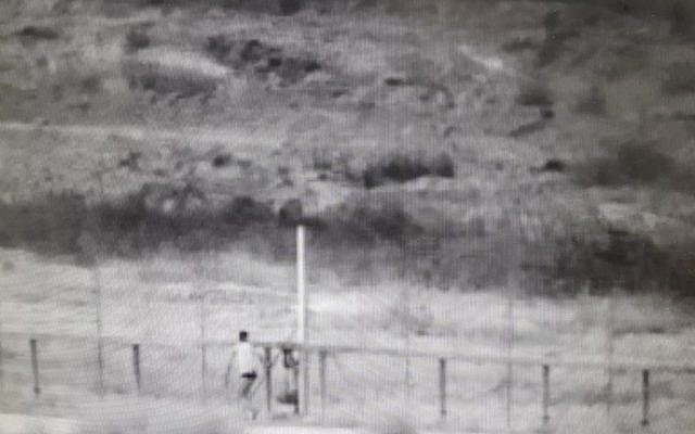 Surveillance footage showing 2 Palestinian men attempting to breach the border fence and enter Israeli territory on June 2, 2018. (IDF)