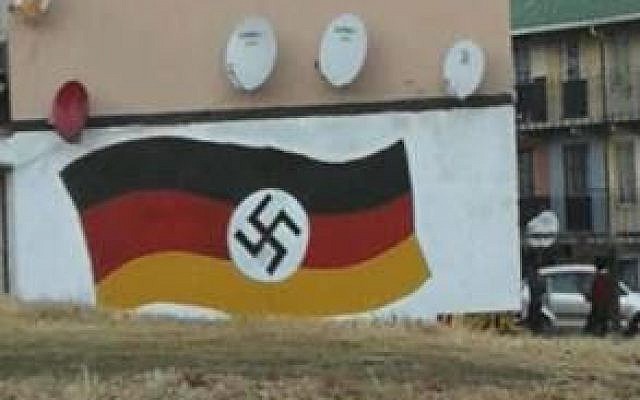 A German flag with Nazi swastika graffitied on a wall in Johannesburg, South Africa, on June 20, 2018. (South Africa Jewish Board of Deputies)