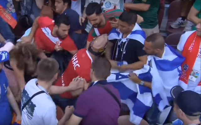 Moroccan soccer fans trying to snatch an Israeli flag at the Luzhniki Stadium in Moscow after a FIFA World Cup match on June 20. (Screen capture: YouTube)