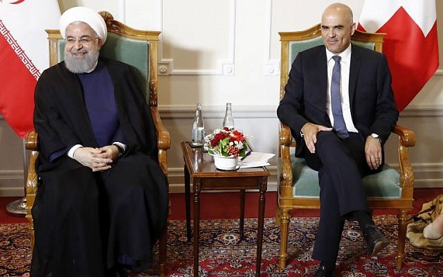Swiss Federal President Alain Berset (R) and Iranian President Hassan Rouhani pose for a picture at the beginning of a meeting during Rouhani's official visit in Bern, on July 2, 2018 (AFP Photo/Pool/Peter Klaunzer)