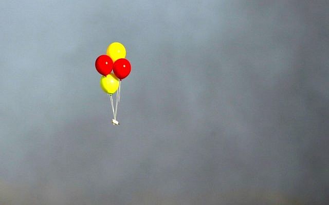 Illustrative: Incendiary balloons are flown toward Israel during clashes between Palestinians and Israeli troops east of Gaza City, along the border between the Gaza Strip and Israel, on July 13, 2018. (AFP Photo/Mahmud Hams)