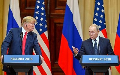 US President Donald Trump (L) listens as Russia's President Vladimir Putin speaks during a joint press conference after a meeting at the Presidential Palace in Helsinki, on July 16, 2018. (AFP/Yuri K adobnov)
