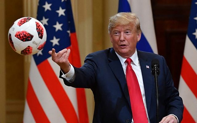 US President Donald Trump throws a soccer ball to his wife (unseen) from the 2018 football World Cup that he received from Russia's President Vladimir Putin during a joint press conference at the Presidential Palace in Helsinki, Finland, on July 16, 2018. (AFP Photo/Yuri Kadobnov)