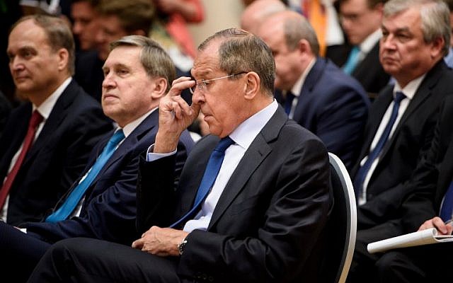 Russia's Foreign Minister Sergey Lavrov and others listen during a press conference by Russia's President and US President at Finland's Presidential Palace July 16, 2018 in Helsinki, Finland. (AFP/Brendan Smialowski)