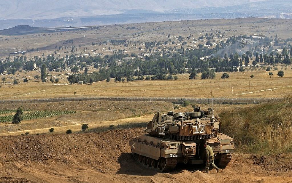 A picture taken on July 20, 2018, in the Golan Heights shows an Israeli Merkava tank taking position on the border between Israel and Syria. (AFP Photo/Jalaa Marey)