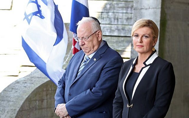 Israeli President Reuven Rivlin, left, and Croatian President Kolinda Grabar Kitarovic pay a tribute at the memorial in the shape of a flower for the victims killed at the Jasenovac concentration camp which was dismantled 73 years ago in Jasenovac, on July 25, 2018.  (AFP/STRINGER)