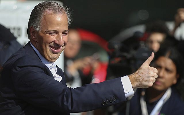 Presidential candidate Jose Antonio Meade, with the Institutional Revolutionary Party (PRI), gives the thumbs up to the press at a polling station during general elections in Mexico City, on July 1, 2018. (AP Photo/Anthony Vazquez)