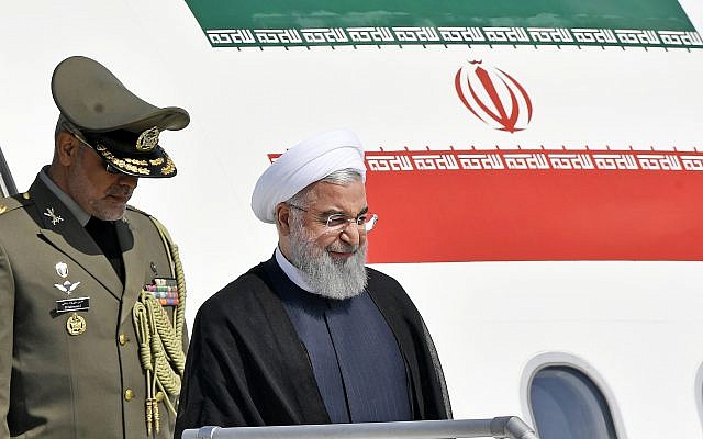 Iranian President Hassan Rouhani, right, arrives at the Zurich airport, in Kloten, Switzerland, July 2, 2018. (KEYSTONE/Walter Bieri via AP)