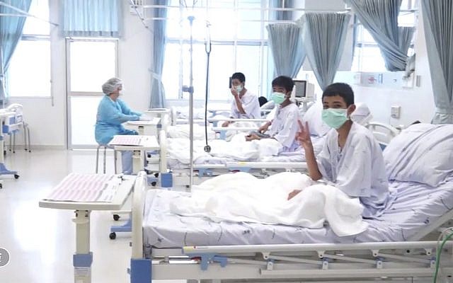 In this image made from video, released by the Thailand Government Spokesman Bureau, three of the 12 boys are seen recovering in their hospital beds after being rescued along with their coach from a flooded cave in Mae Sai, Chiang Rai province, northern Thailand, July 11, 2018. (Thailand Government Spokesman Bureau via AP)