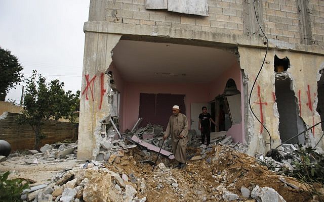 File: A Palestinian inspects the family house of Omar Al-Abed after it was demolished by Israeli authorities in the West Bank village of Kobar, near Ramallah, Aug. 16, 2017. Al-Abed stabbed to death three Jewish residents of a nearby settlement in July 2017. (AP Photo/Nasser Shiyoukhi)